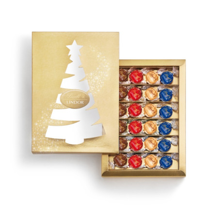 Caixa dourada com bonbons coloridos e desenho de árvore de natal na tampa